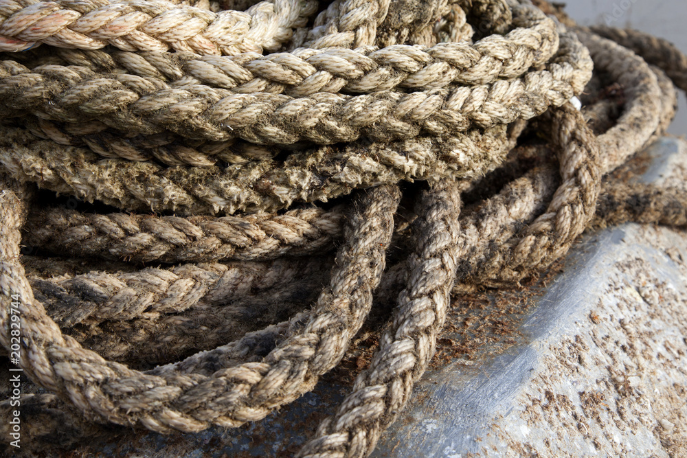 Thick braided rope. Texture of a braided rope. Fishing net.	