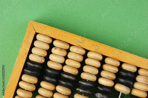 old abacus on the green background