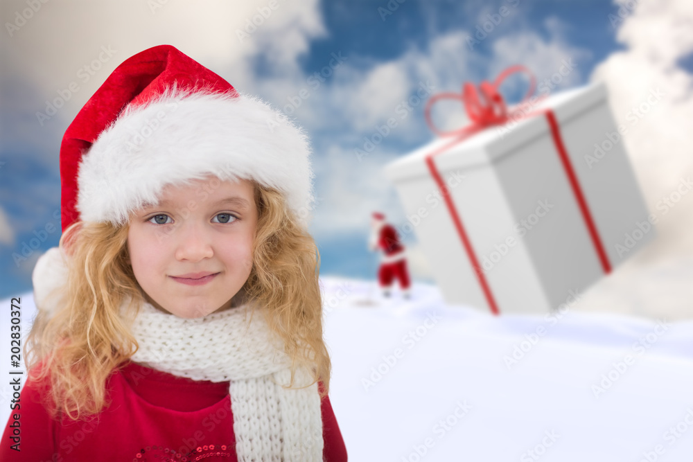 Cute girl in santa hat against blue sky with white clouds Cute girl in santa hat against blue sky with white clouds