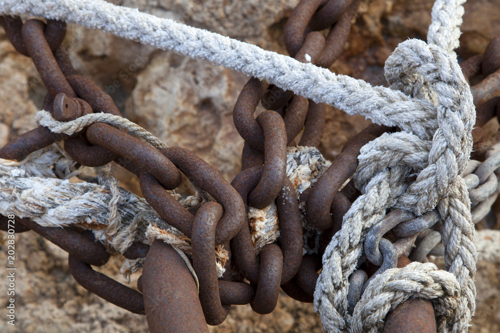 Rusty chain and berthing moorings. Sea rope. Texture of braided rope.  Fishing net. Stock Photo