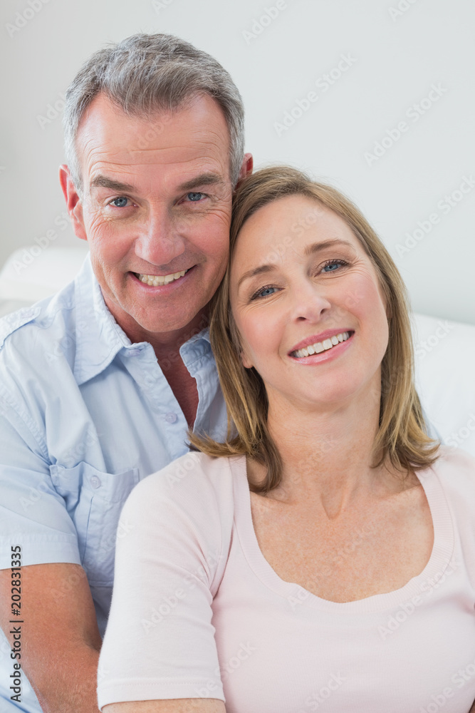 Portrait of a happy couple embracing at home