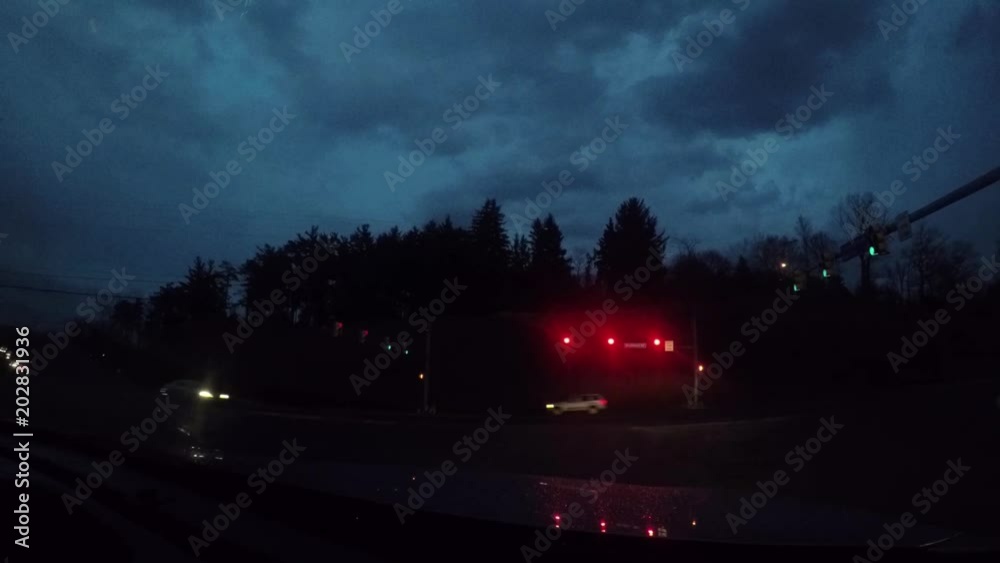 Waiting at a red light with a go pro in the night on busy road