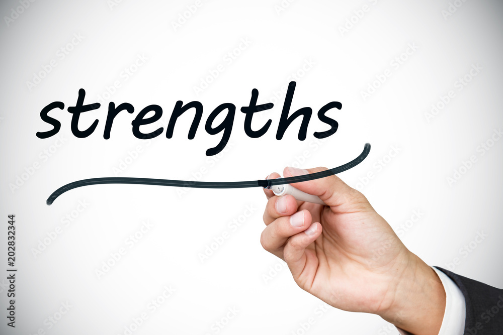 Businessman writing the word strengths against white background with vignette