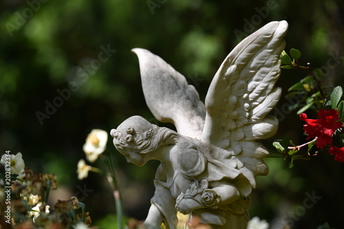 Fototapeta Naklejka Na Ścianę i Meble -  Sculpture of an angel who spreads his wings