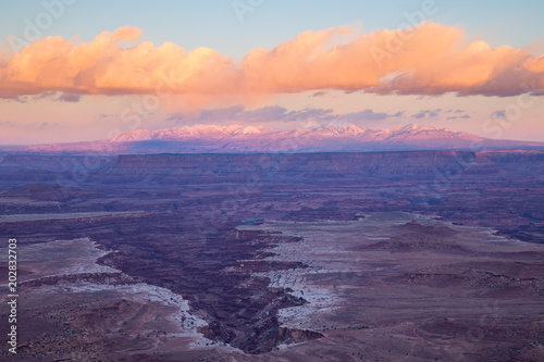 Canyonlands National Park Island in the Sky overlook of the White Rim and the La Sal Mountains near Moab, Utah at sunset with clouds © Rebecca