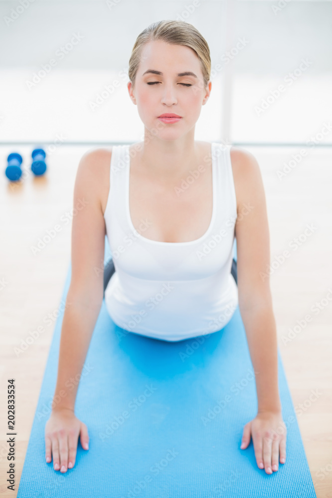 Relaxed fit woman stretching on sport mat Relaxed fit woman stretching on sport mat