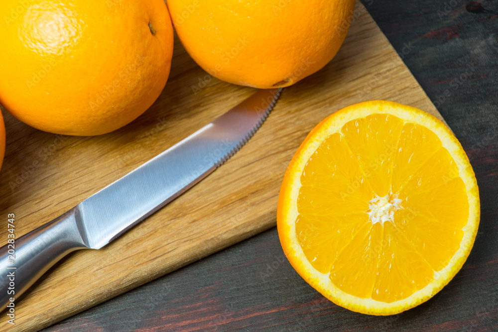 Juicy orange cut in half to make orange juice for Breakfast. Juicy orange cut in half to make orange juice for Breakfast.