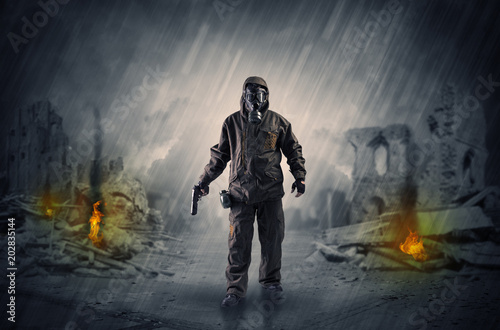 Destroyed place after a catastrophe with man in gas mask and weapon on his hand   © ra2 studio