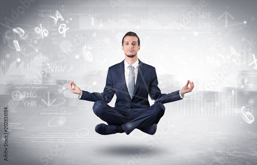 Businessman meditates with enlightenment data reports and financial concept 