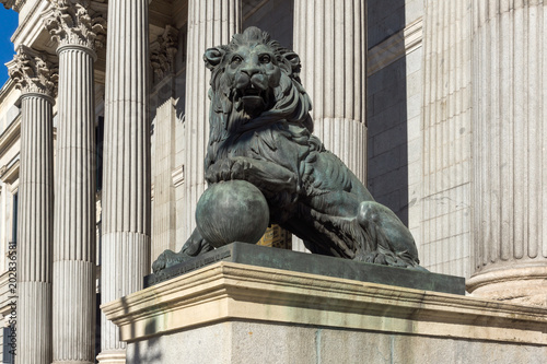  Lion sculpture in front of Building of Congress of Deputies (Congreso de los Diputados) in City of Madrid, Spain 