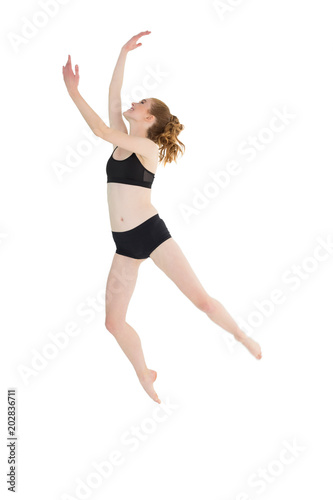Full length of a sporty young woman jumping