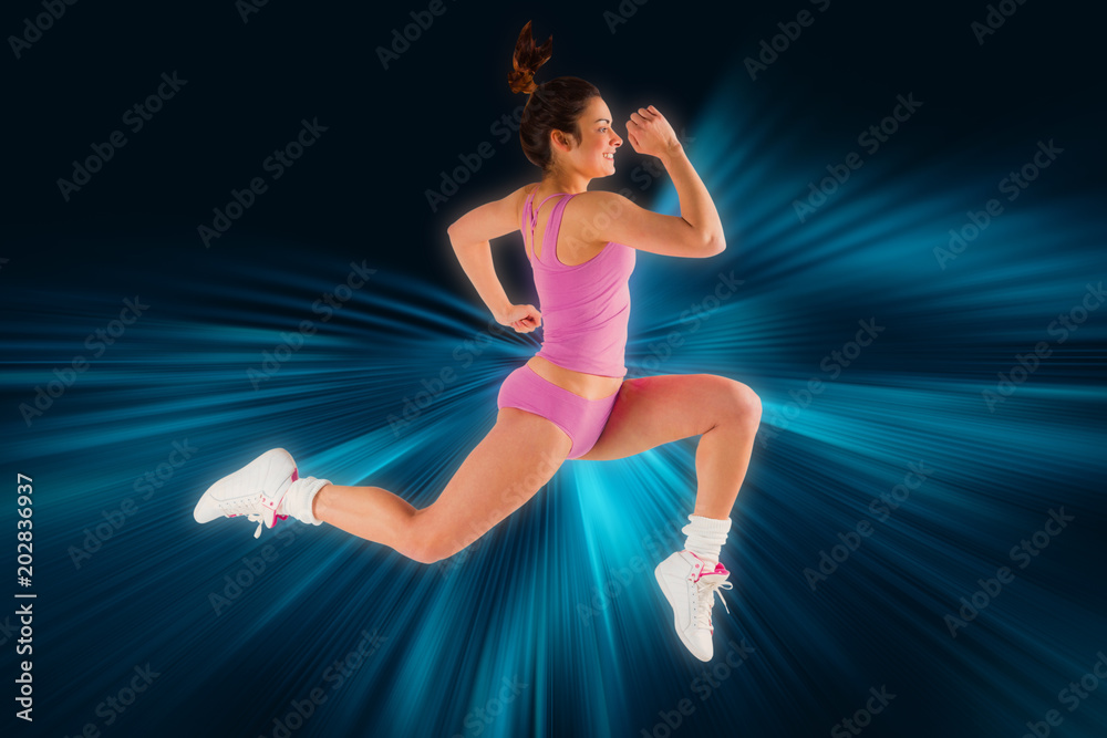 Fit brunette running and jumping against abstract background