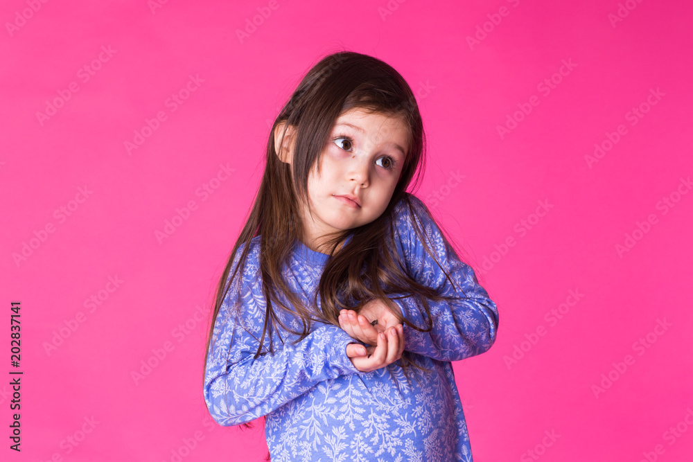 Portrait of a charming brunette little child girl, isolated on pink background Portrait of a charming brunette little child girl, isolated on pink background