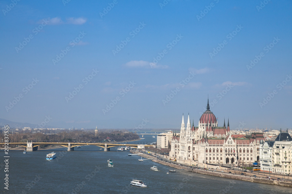 Panorama of Budapest with the Hungarian Parliament (orszaghaz) seen from the Budapest castle, the Danube river being in front with ships passing by.