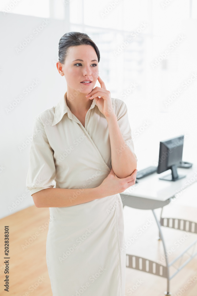 Serious businesswoman looking away in office Serious businesswoman looking away in office
