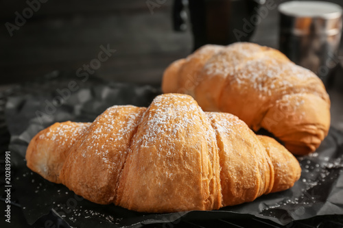 Tasty croissants with sugar powder, closeup