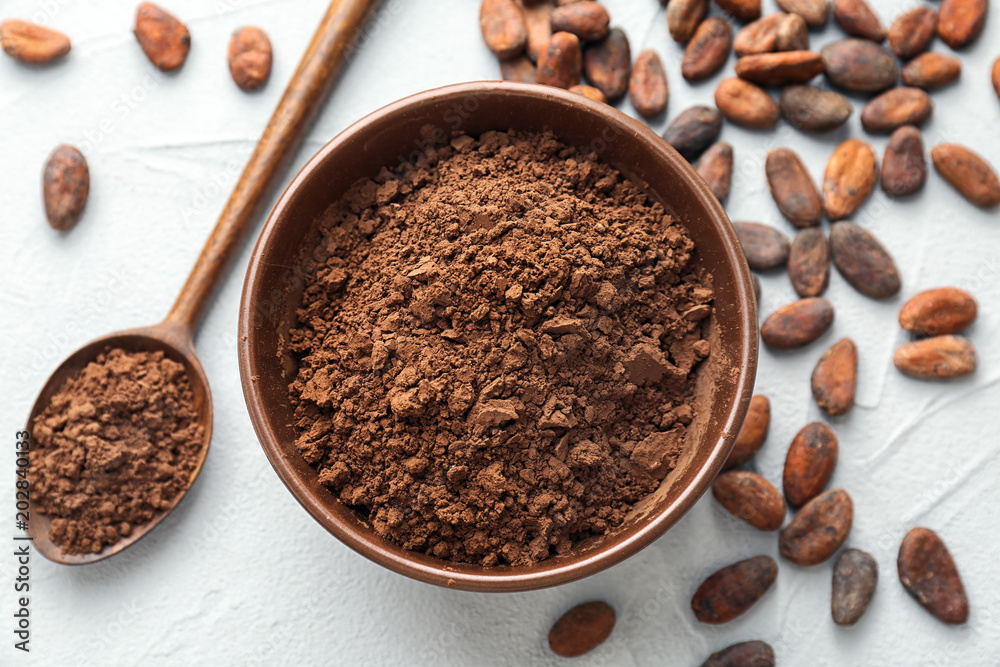 Flat lay composition with cocoa powder and beans on light background Flat lay composition with cocoa powder and beans on light background