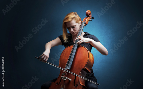 Fototapeta Lonely cellist composing on cello with nothing around