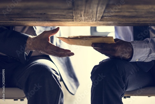 Business people sending documents under the table photo