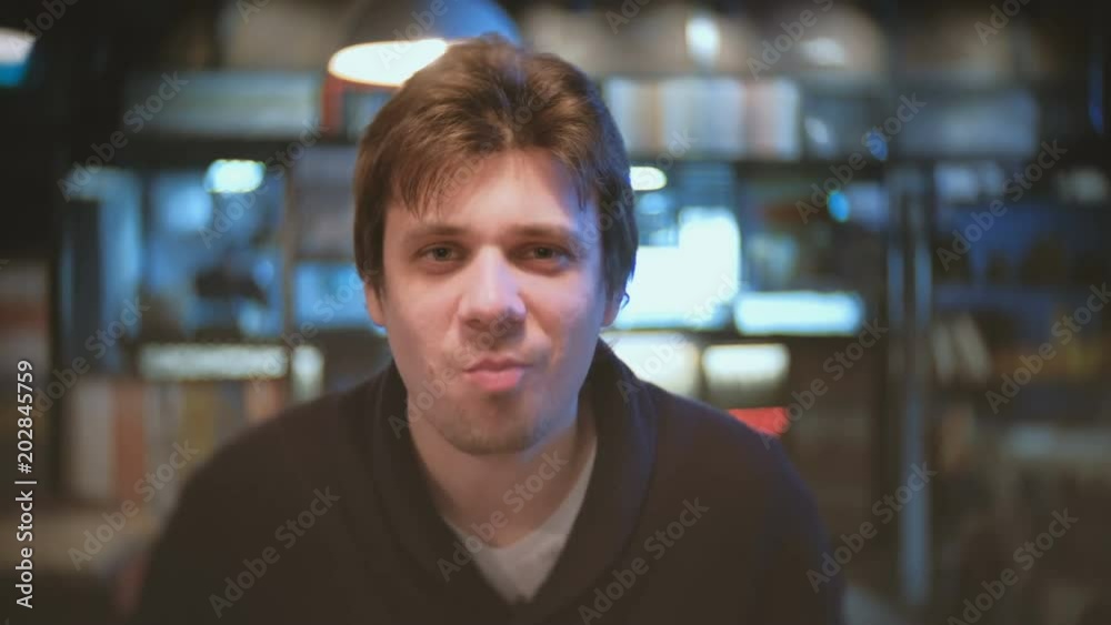 Young man brunet eating in cafe.
