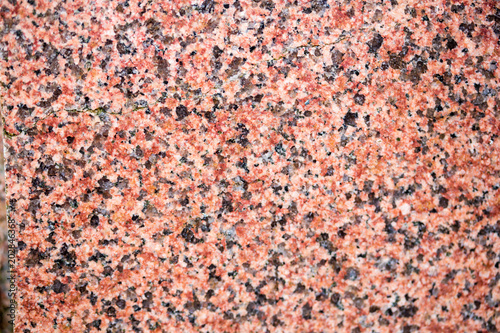 Natural stone red granite texture background. Red granite texture stone background. Red granite texture untreated surface. © Alexey Lesik
