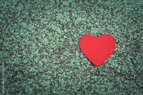 red heart on the green walking path backgrounds with copy space