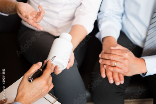  doctor hand holding tablet of drug and explain to patient in hospital room.