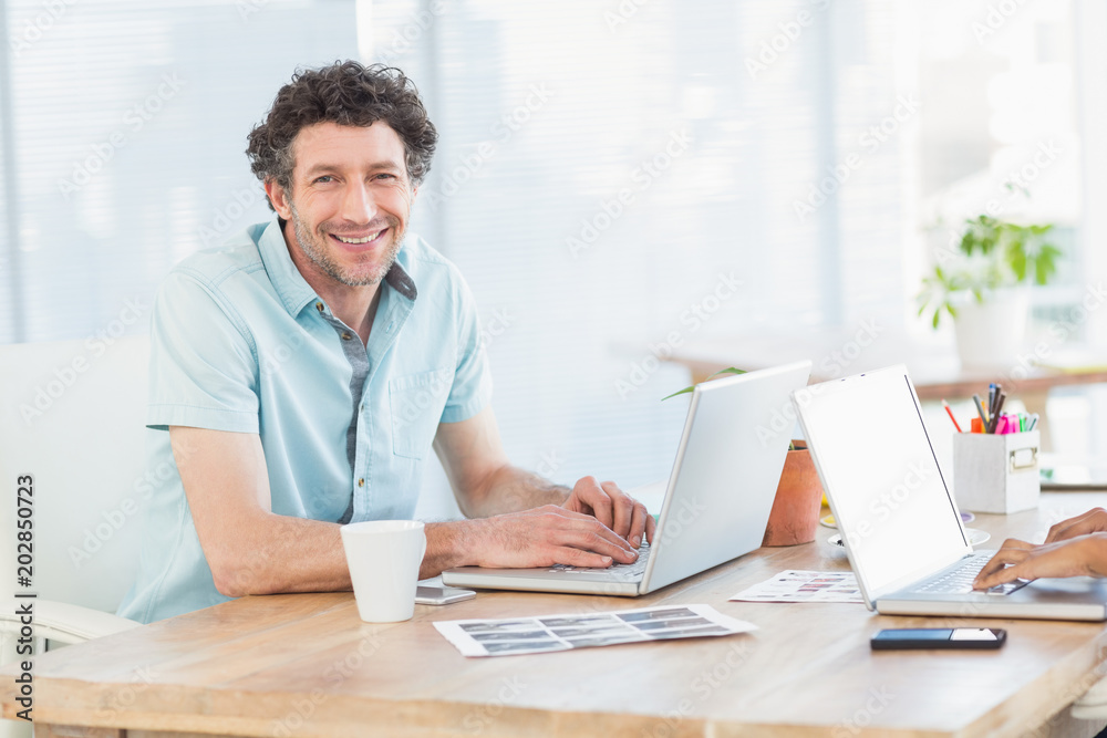 Casual business partners looking at laptop Casual business partners looking at laptop