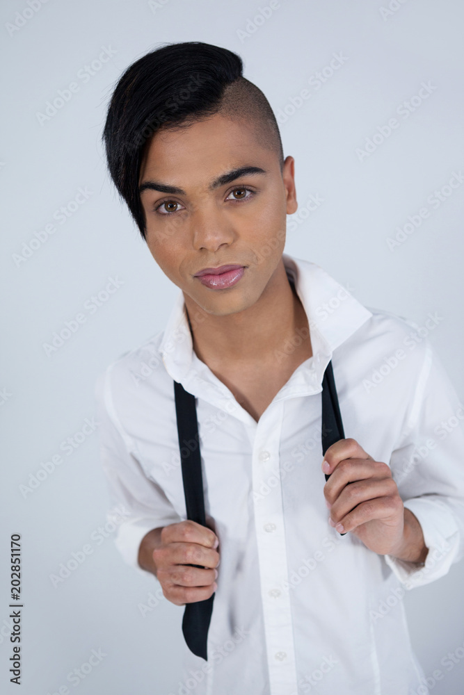 Portrait of confident transgender woman holding tie Portrait of confident transgender woman holding tie