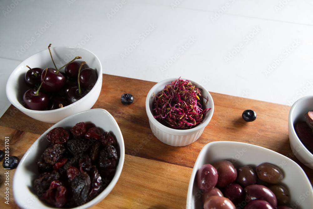 Εκτύπωση καμβά Close-up of olives with various fruits in bowl on cutting board