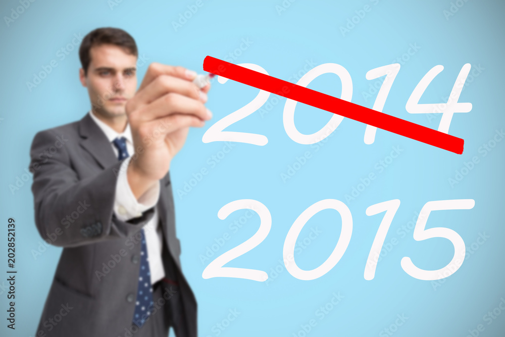 Concentrated businessman holding red marker against blue background with vignette Concentrated businessman holding red marker against blue background with vignette