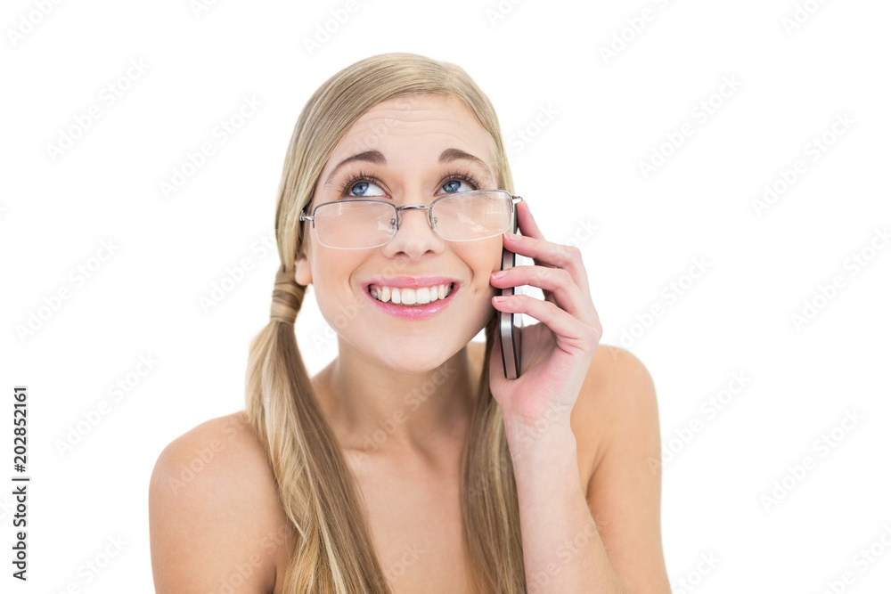 Embarrassed young blonde woman calling someone with her mobile phone Embarrassed young blonde woman calling someone with her mobile phone