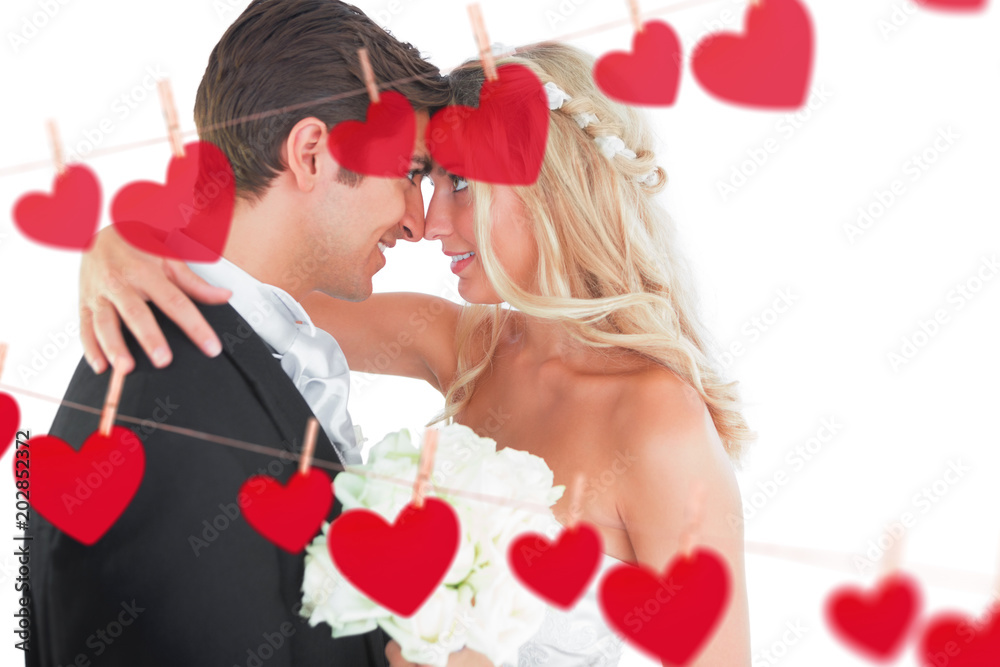 Φωτογραφία Beautiful young married couple looking each other in the face against hearts han