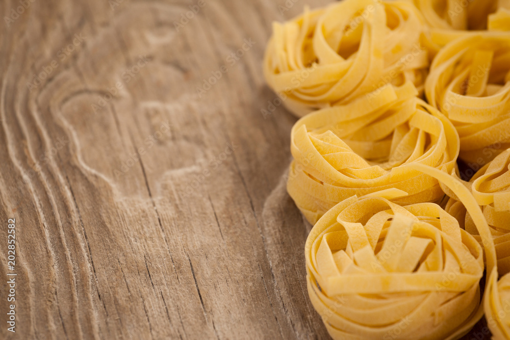 Fettuccine pasta arranged in a row Fettuccine pasta arranged in a row