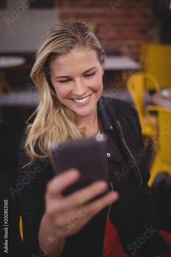 Attractive young woman using mobile phone