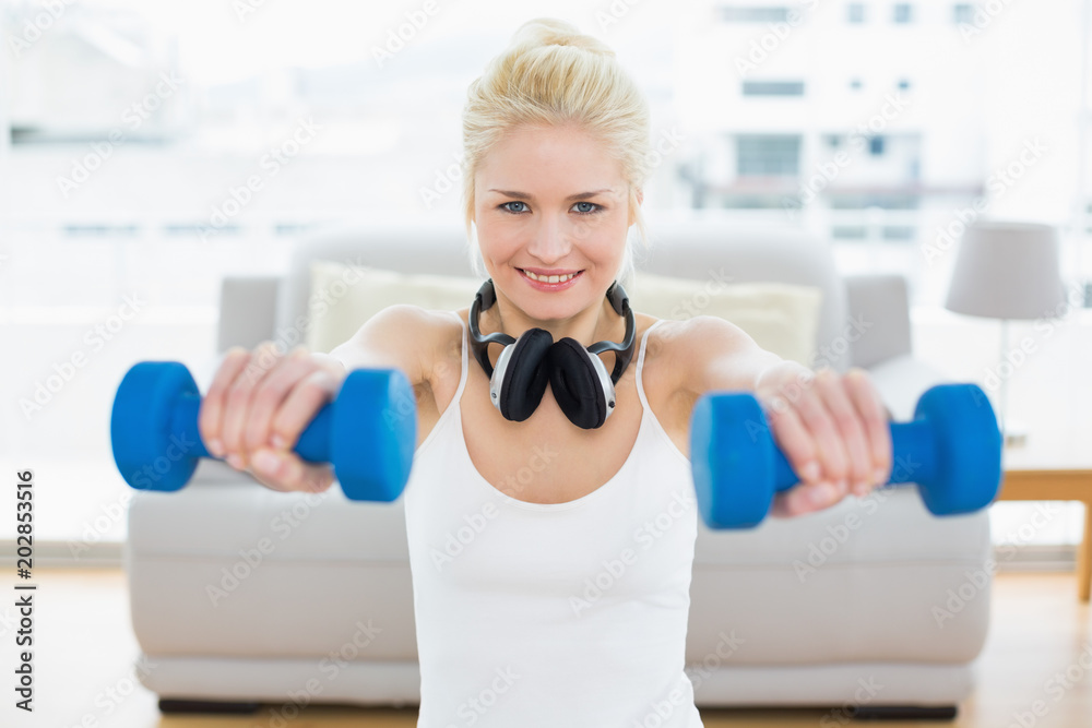 Smiling woman with dumbbells at fitness studio Smiling woman with dumbbells at fitness studio