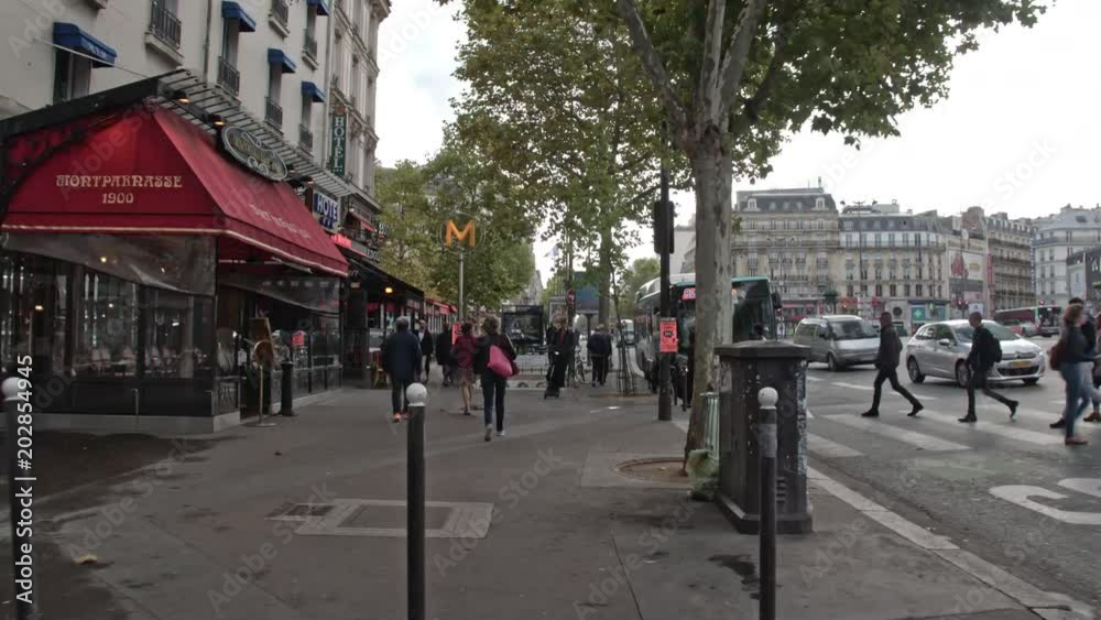 PARIS, FRANCE - SEPTEMBER 29, 2017: Timelapse shot of walking on roadside sidewalk in busy city street. Passing by cafes and stores PARIS, FRANCE - SEPTEMBER 29, 2017: Timelapse shot of walking on roadside sidewalk in busy city street. Passing by cafes and stores