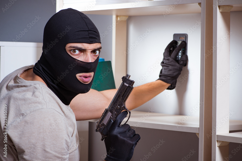 Burglar wearing balaclava mask at crime scene Burglar wearing balaclava mask at crime scene