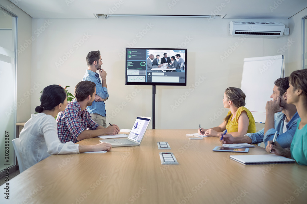 Business interface against attentive business team following a presentation Business interface against attentive business team following a presentation