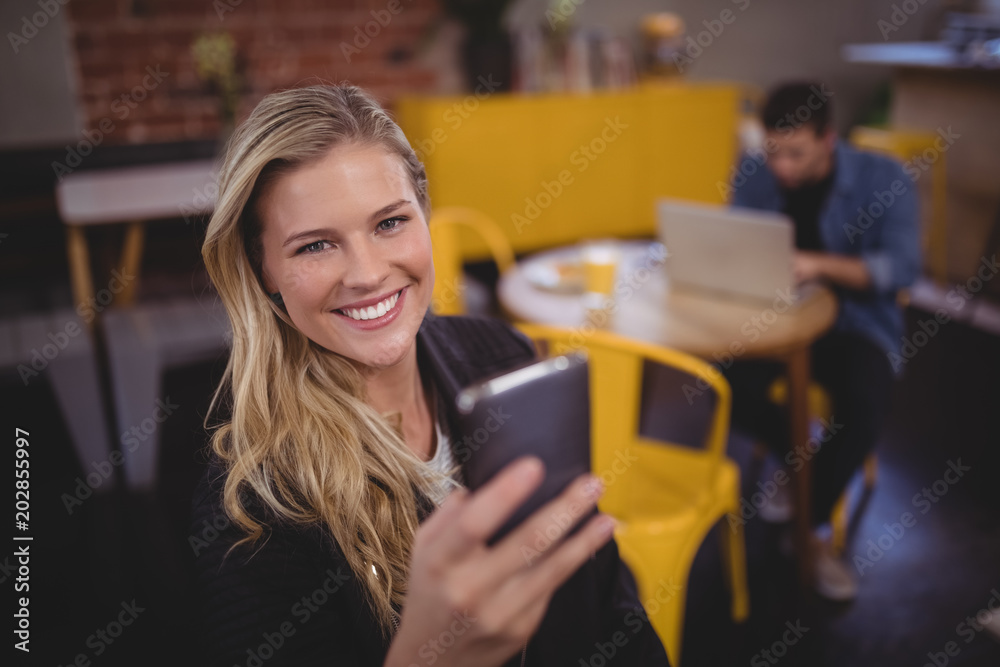 Portrait of smiling young attractive woman using mobile phone Portrait of smiling young attractive woman using mobile phone