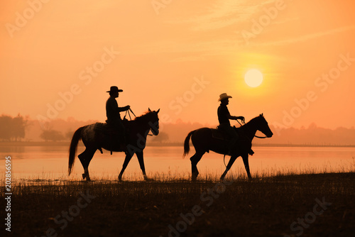 cowboy and horse with sunset background