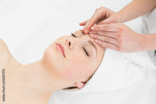 Hands massaging a beautiful womans forehead © WavebreakmediaMicro