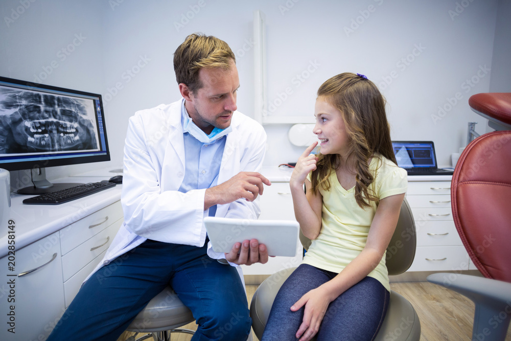Young patient showing teeth to dentist Young patient showing teeth to dentist