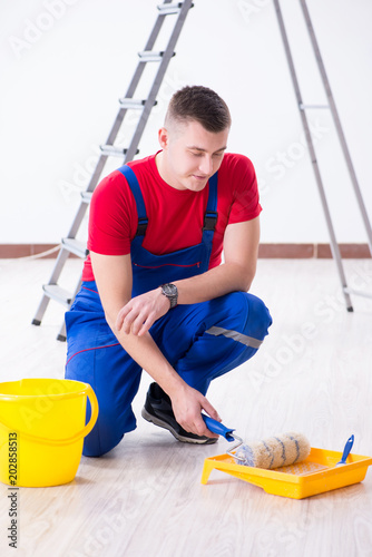 Male painter preparing for painting job at construction site