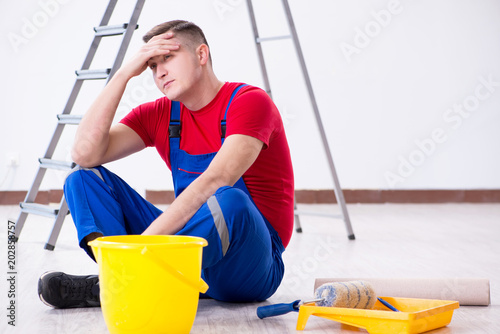 Male painter preparing for painting job at construction site