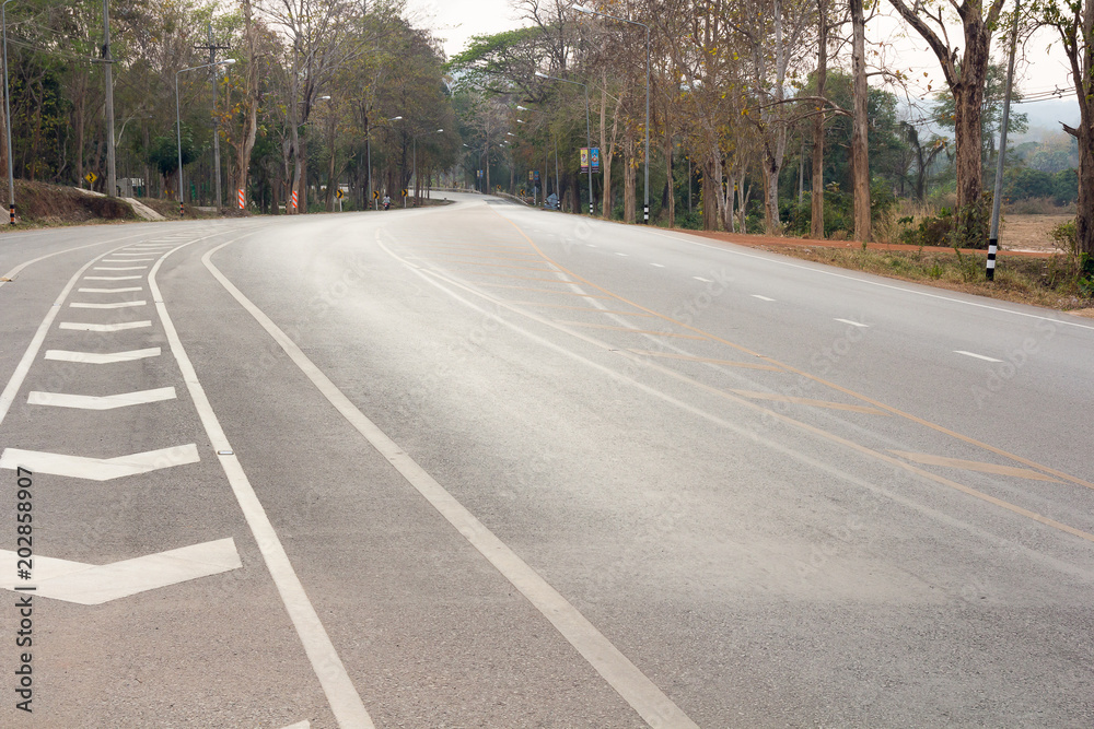 Fototapeta premium road up hill to the mountain top at at sunny sunset.