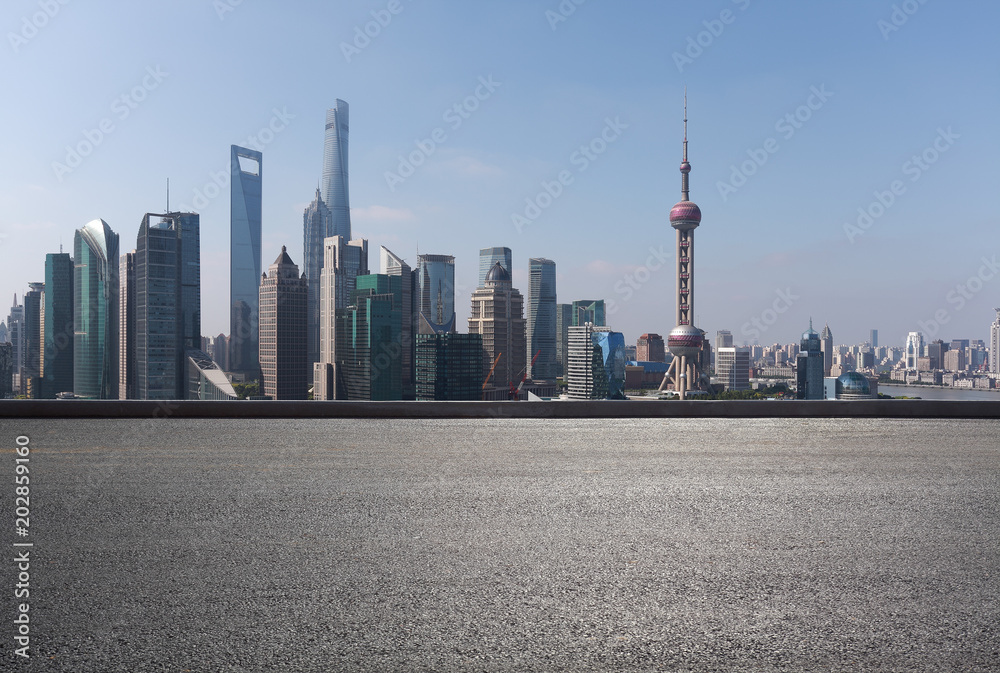 Empty road surface floor with city landmark buildings of Shanghai Skyline