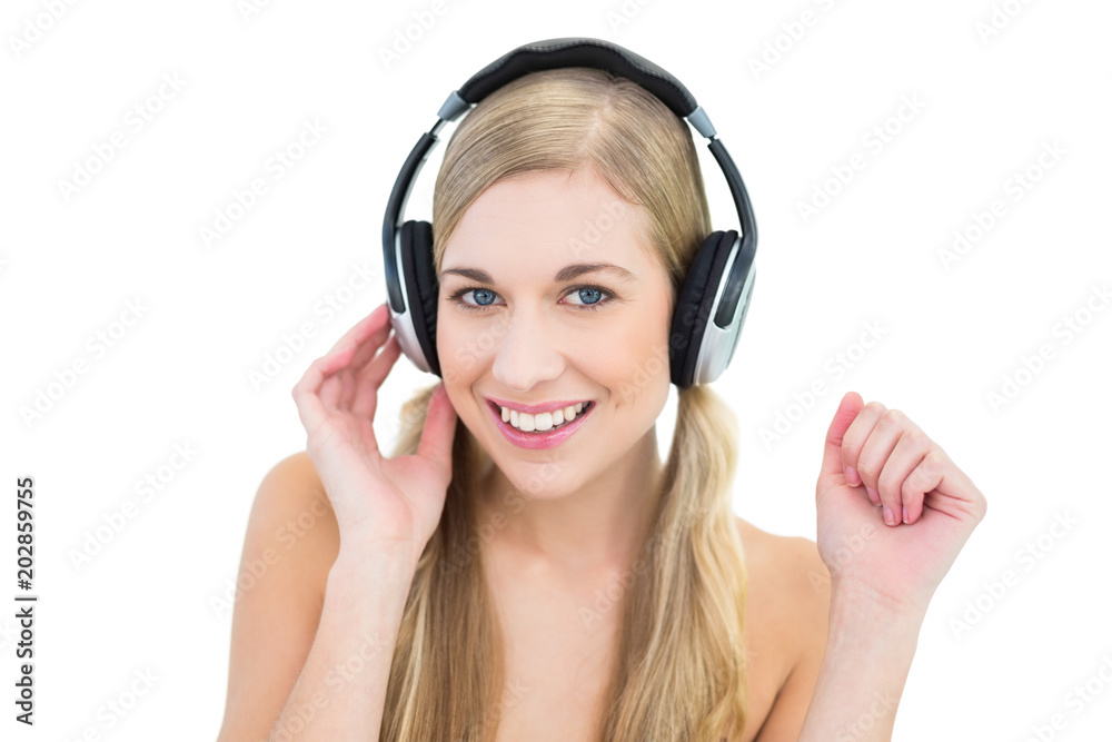 Pretty young blonde woman enjoying music