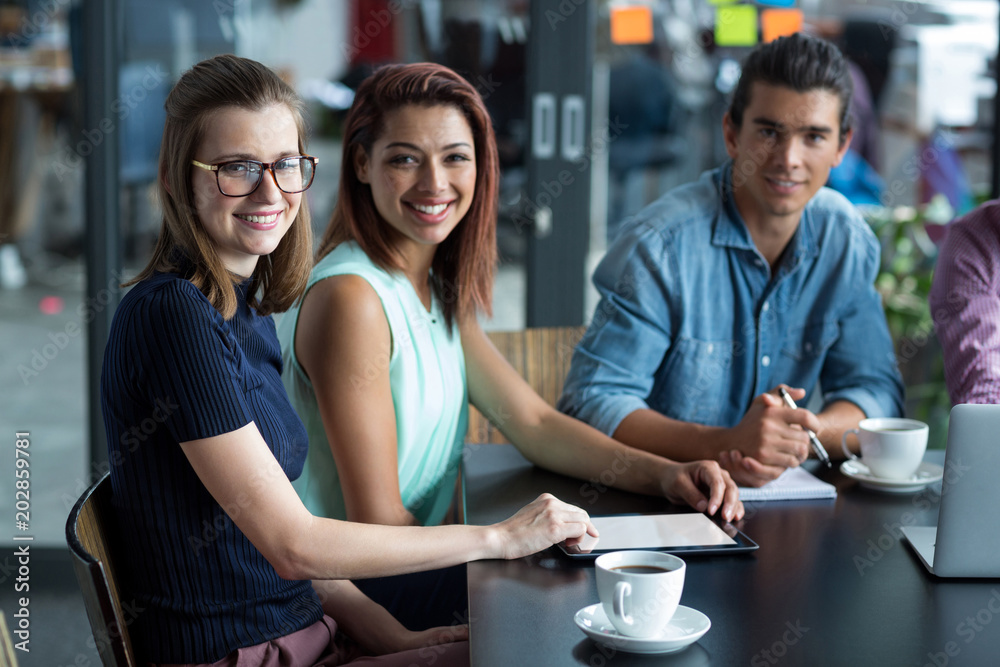 Portrait of business executives sitting in office Portrait of business executives sitting in office
