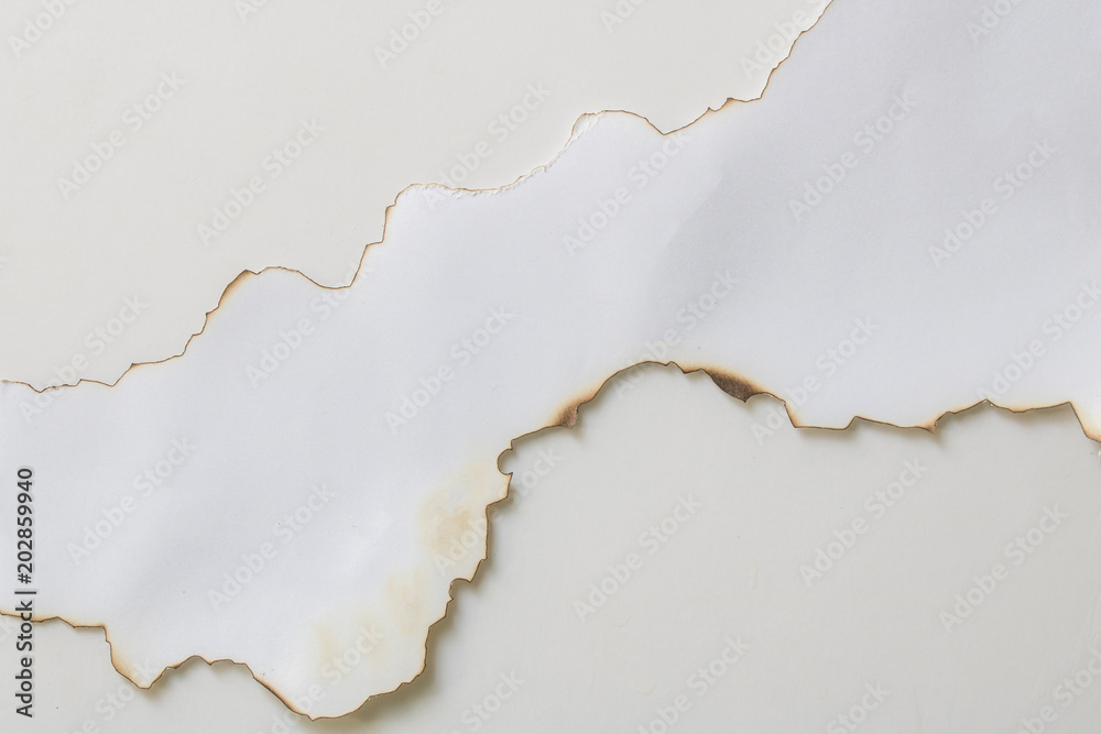 Close up paper burns edge with shadow on a white backgrounds use for design or wallpaper